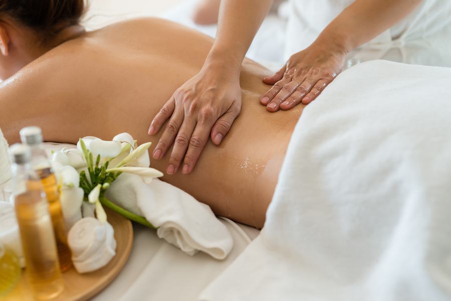 Long gliding strokes worked across the back during a Silk Thai Signature session